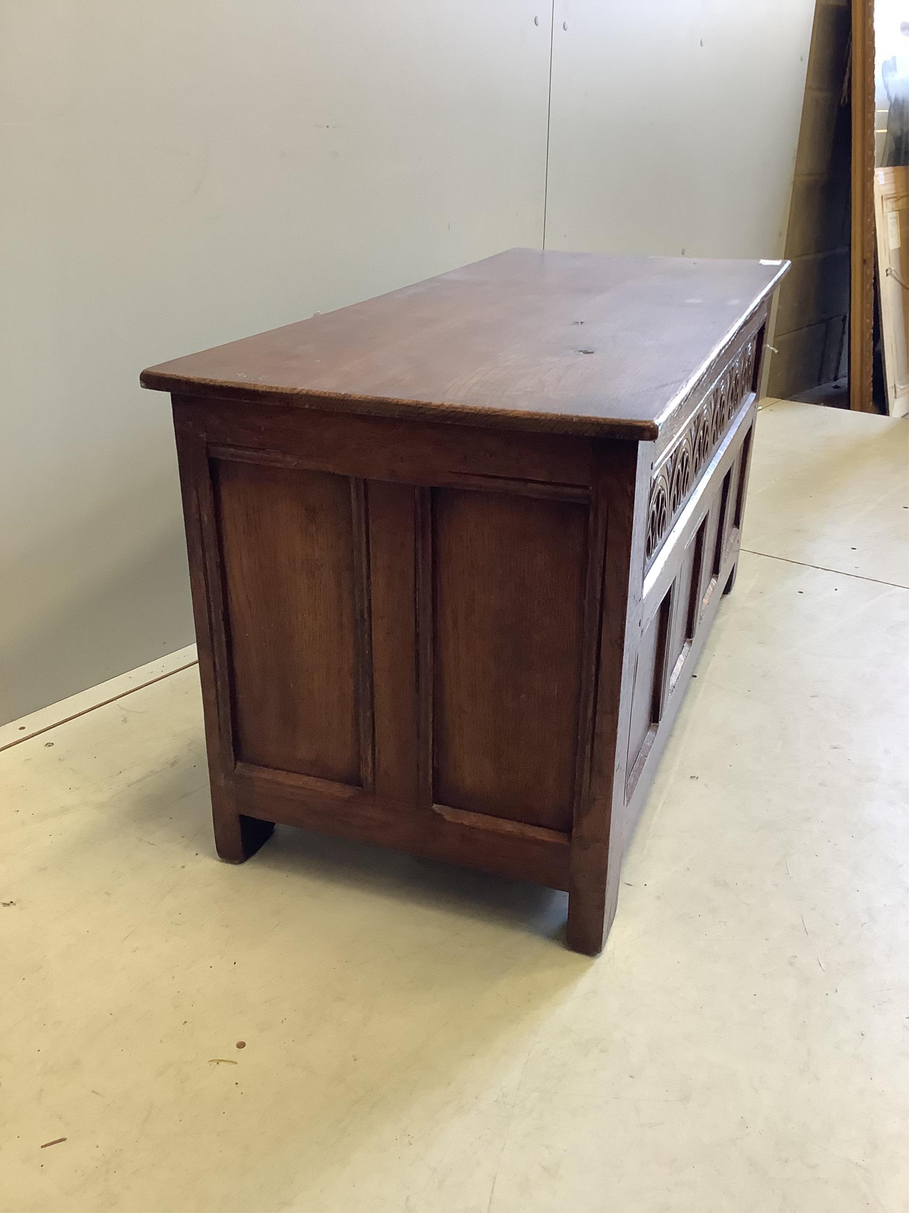 A reproduction 18th century style carved oak coffer, width 106cm, depth 46cm, height 54cm together with an elm and beech Windsor elbow chair. Condition - fair
